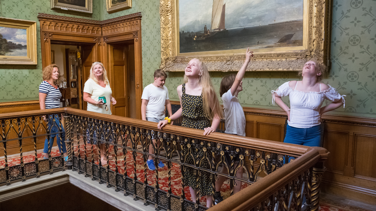 Family with teenage children exploring the house